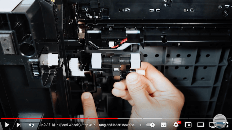 A printer technician inserts new feed wheels on the Xerox VersaLink B625