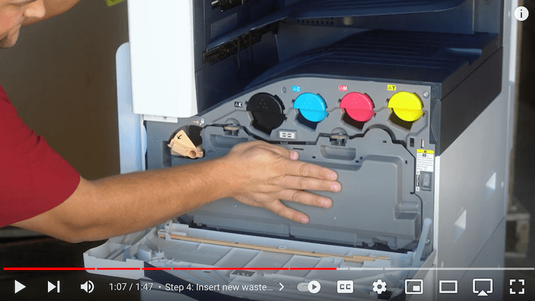 Printer technician pushes in the new waste cartridge on the Xerox VersaLink C7030