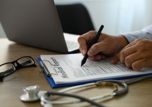 A medical staff writes on medical records