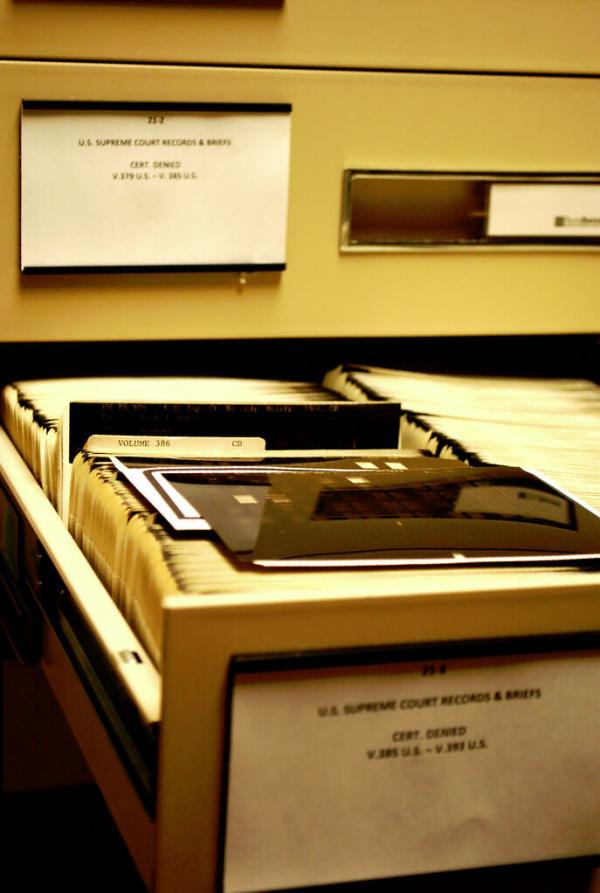 An open file cabinet filled with documents