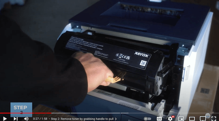 Printer technician removes the toner on the Xerox B410/B415